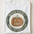 WARM NIGHTS AND PUMPKIN LIGHTS | Cozy Halloween T-Shirt - close up